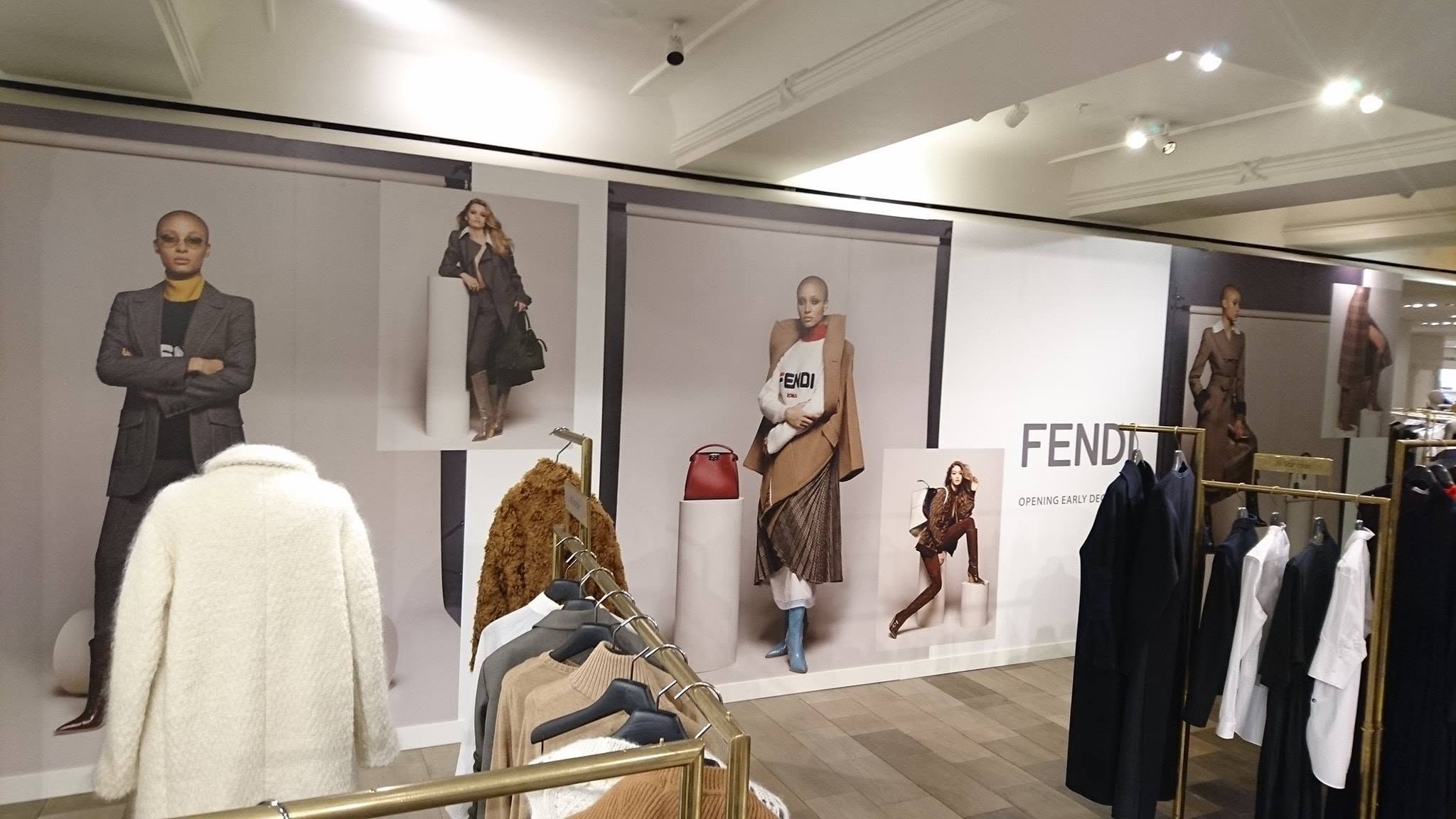 Luxury Fendi retail branding installed behind clothing displays